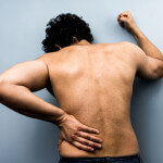 Young man with severe backpain from sciatica