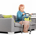 Woman standing up from a sofa with walker