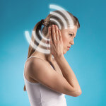 Ear therapy. Stressed girl suffering from noise.